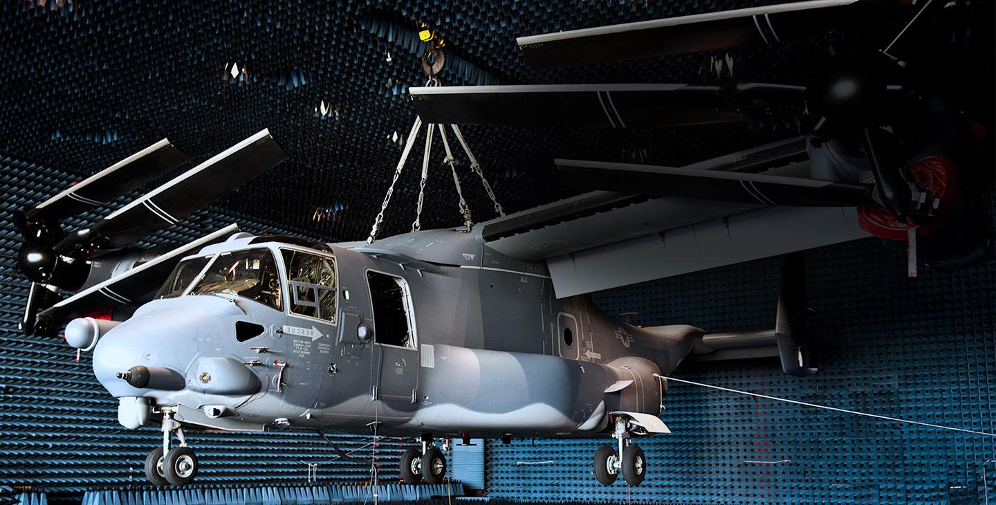Gray helicopter hanging from the ceiling of an anechoic chamber